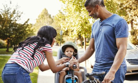 Getting your child ready to use a rear bike seat - strapping them in