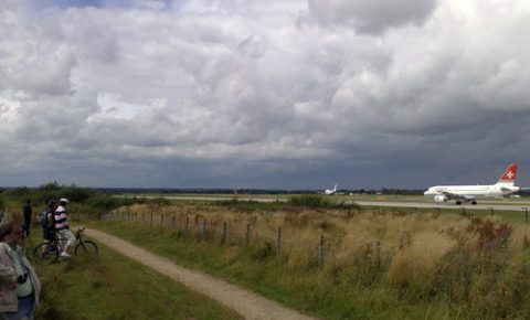 Family bike ride at Manchester Airport, cycle past the planes