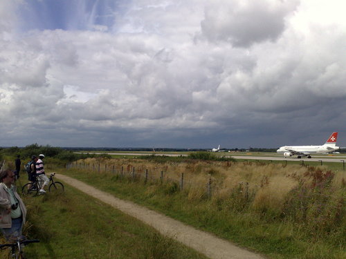 Family bike ride at Manchester Airport, cycle past the planes