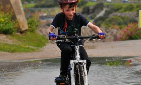 Riding in puddles on the NCN5 near Rhos-on-Sea