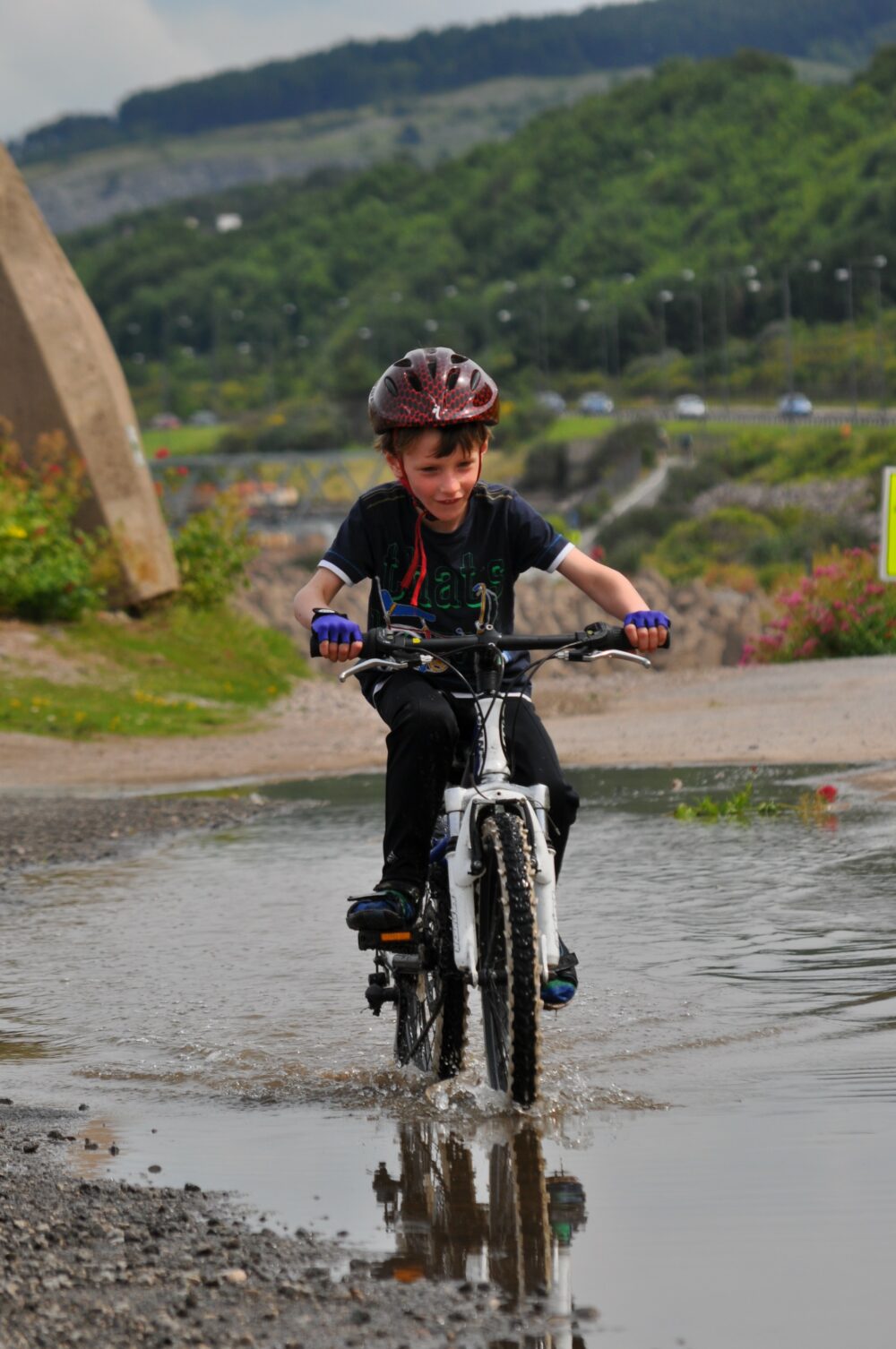 Riding in puddles on the NCN5 near Rhos-on-Sea