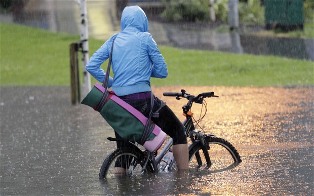 Cyclist in floodwater UK