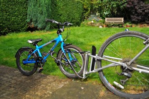 FollowMe Tandem cycle hitch in place with childs bike being towed behind the adult bike