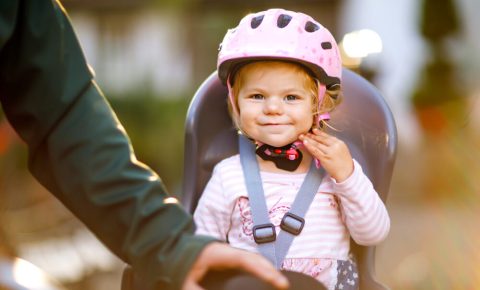 Little girl in a rear bike seat