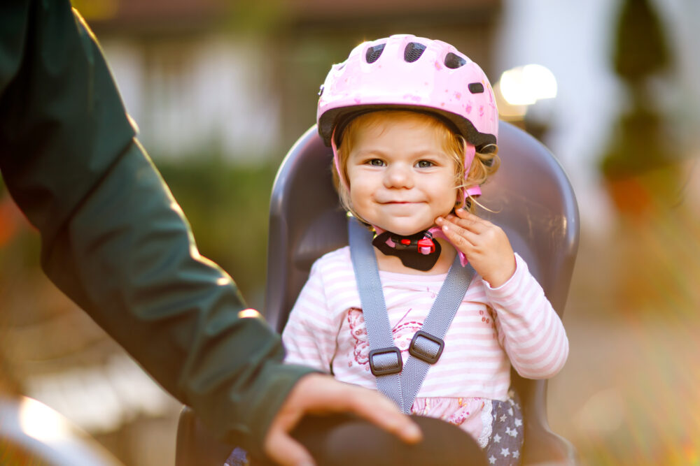 Little girl in a rear bike seat