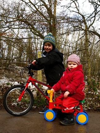 Toddlebike review - how good is a toddlebike at teaching balance? The image shows our 2 year old reviewer on the Lena My First Scooter next to their older brother who is riding a pedal bike