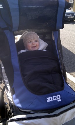 Zigo Leader tricycle for carrying children - Alby looking very happy and comfy