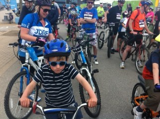 Using a tagalong to tow a child behind an adult bike at the Greater Manchester Cycle family ride