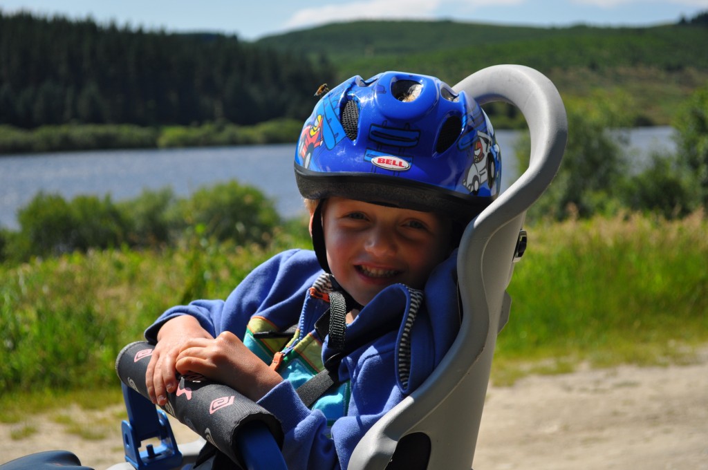 Rear child bike seat for toddlers and small children which fixes on the back of an adult bike for family bike rides with small children