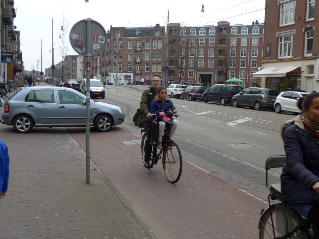 Photo of cycling with child on front of bike in Amsterdam, Holland 2016