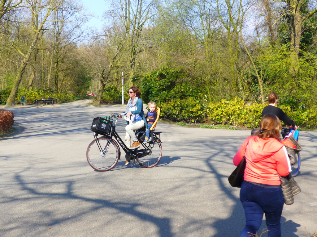 Cycling with a child in a rear bike seat in Amsterdam