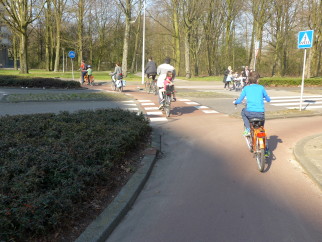 Cycling with kids across a junction in Amsterdam