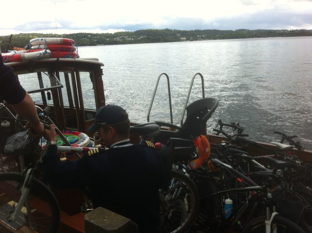 Loading bike with kids bike seat onto the Windermere Bike Boat