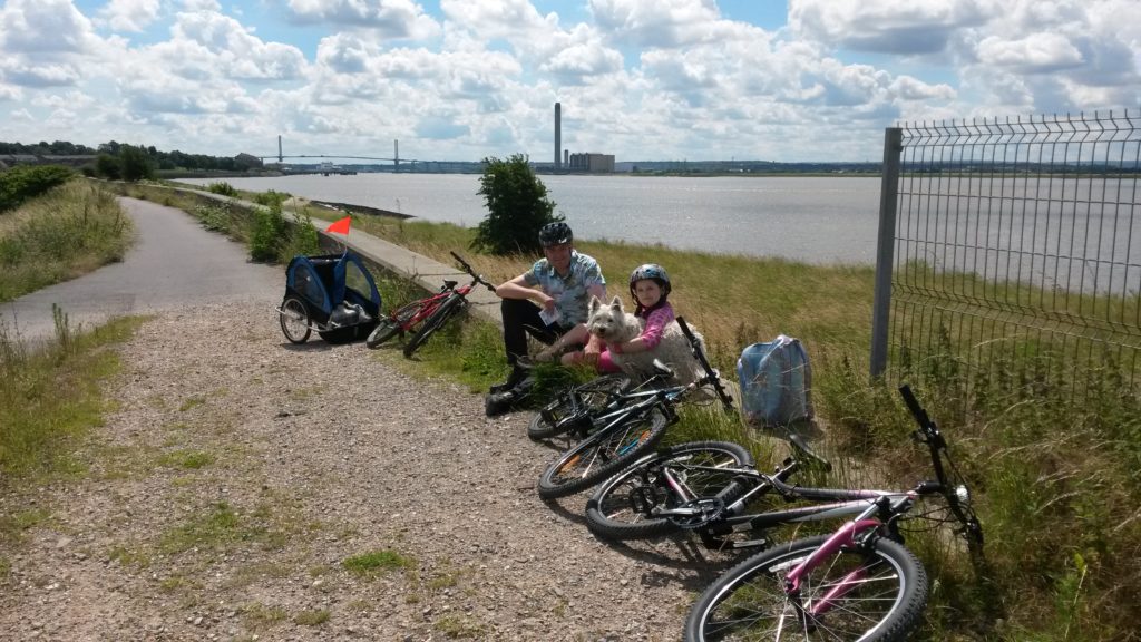 Enjoying a rest during a family cycle ride at Rainham Marshes RSPB nature reserve