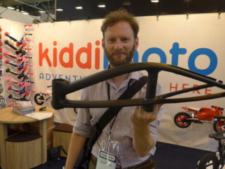 Kiddimoto Karbon balance bike being lifted by one finger