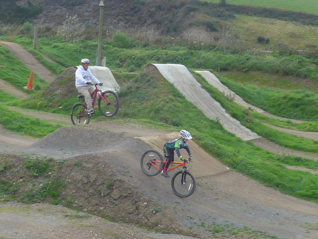 Dad cycling at The Track bike park in Cornwall