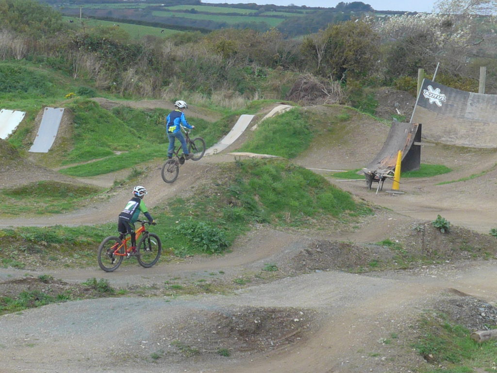 Riding the jumps at The Track Bike Park, Redruth, Cornwall