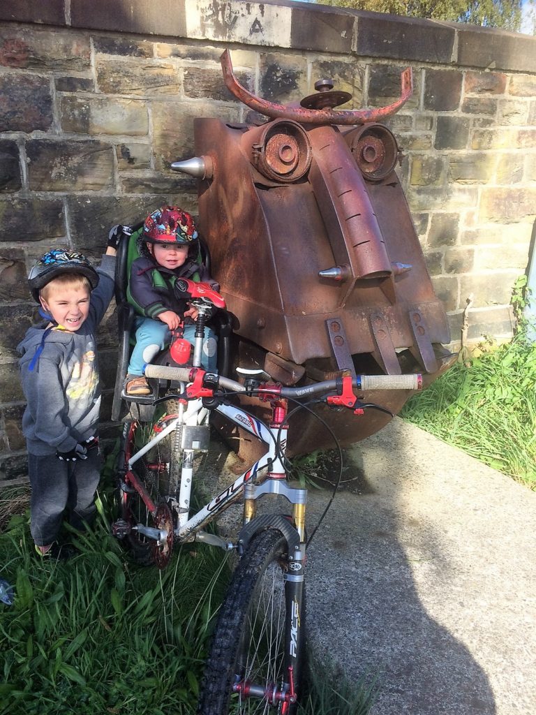 Family cycling along the Spen Valley Greenway- a disused railway in West Yorkshire