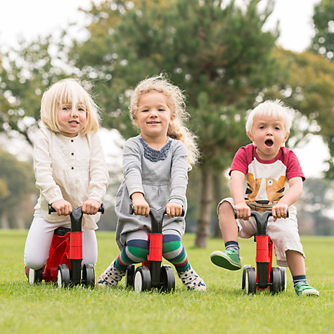 How to choose the right size kids' bike: Three little girls on toddle bikes in a park