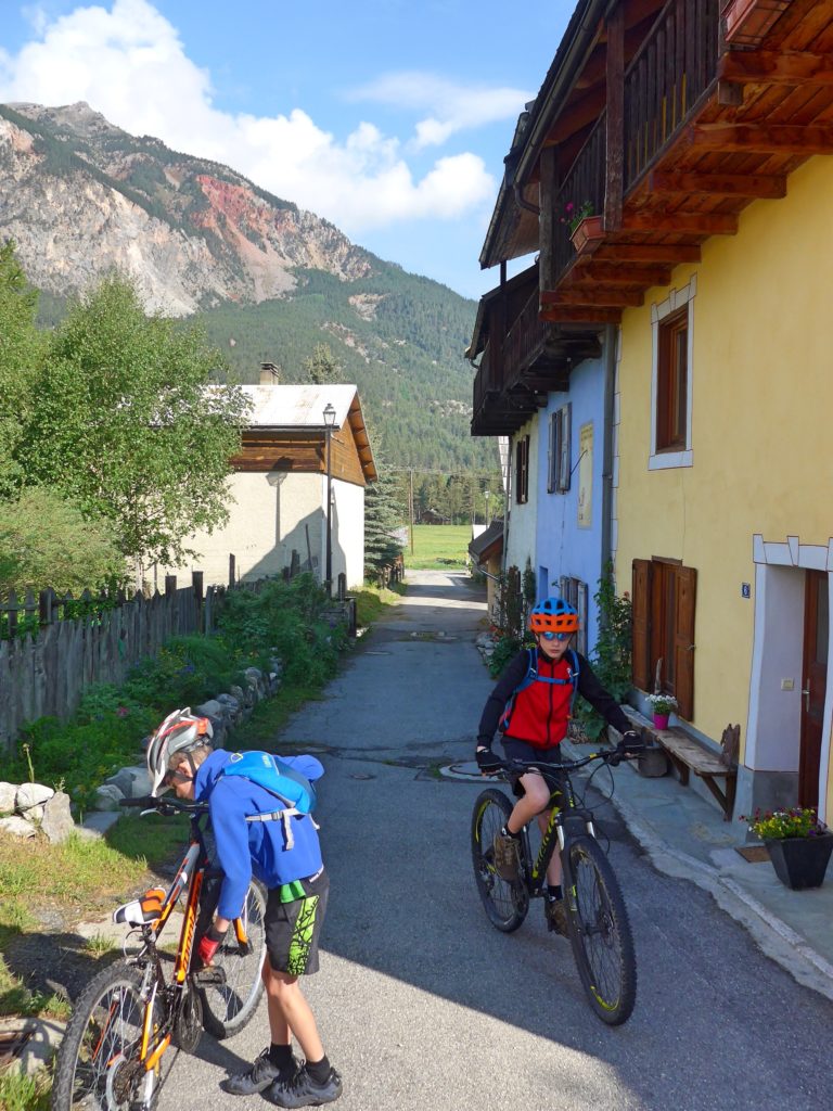 Family cycling in the Vallée de la Clarée in the French Alps - boys getting ready to ride