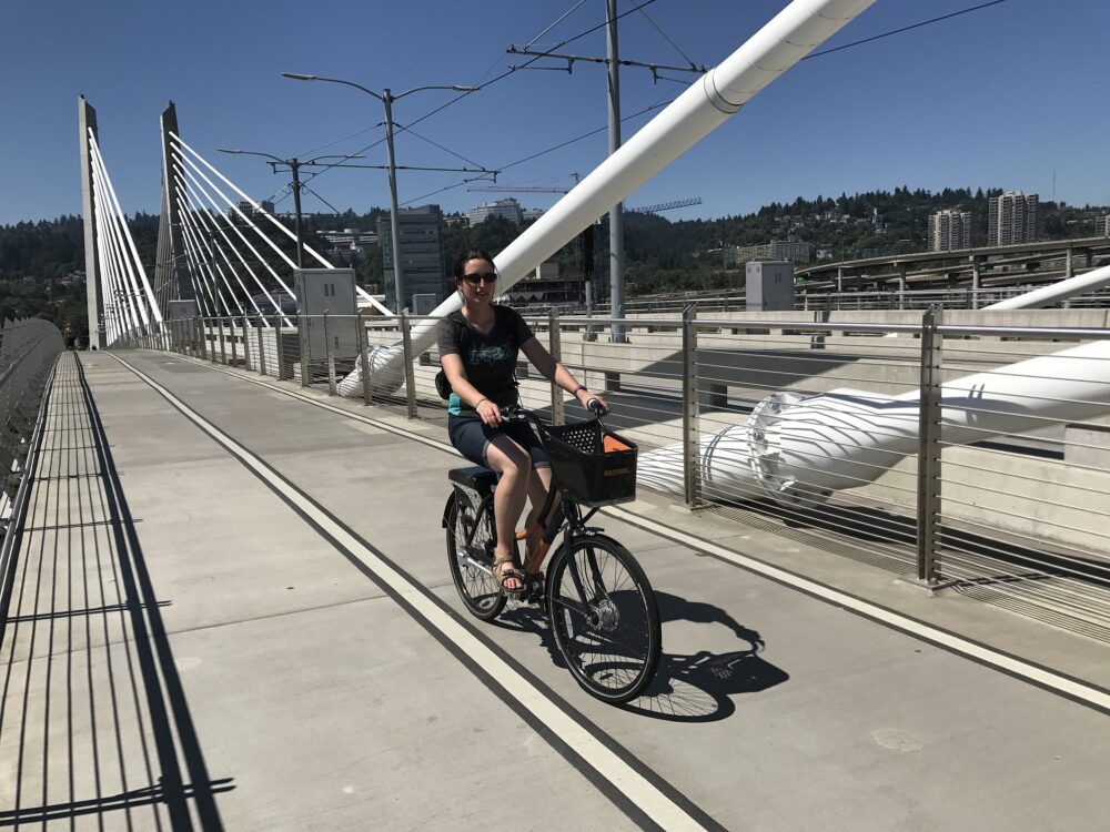 Karen riding across the Tilikum Crossing Portland