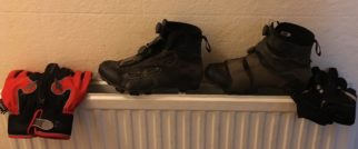 Drying the wet cycle shoes and gloves on the radiator during the Lands End to John O'Groats attempt New Year 2017/18