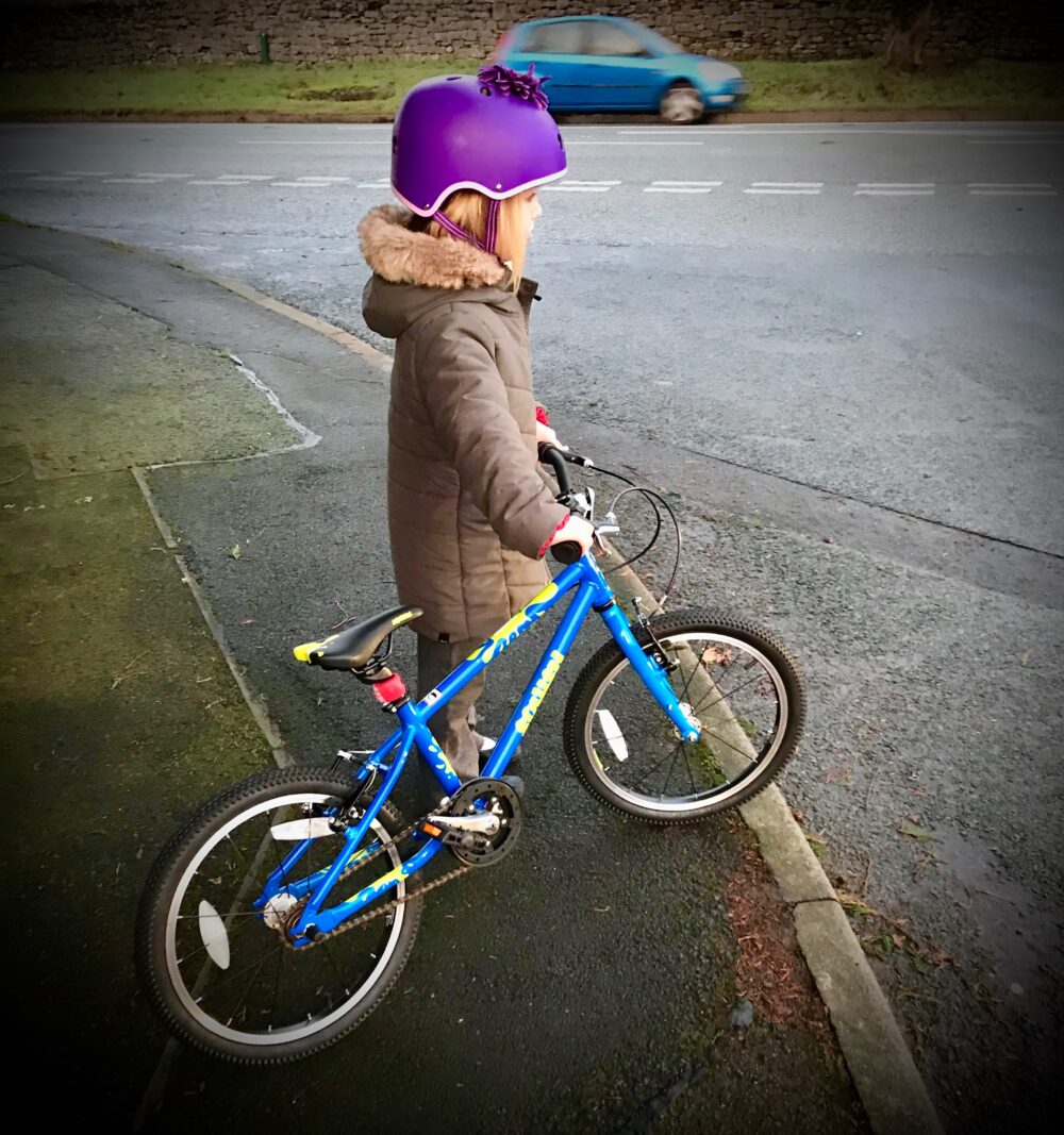 Squish 18 – the ride to school campaign for cycling infrastructure: Girl on the pavement with her bike