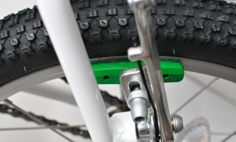 Green brake blocks on the Woom 3 16" wheel kids bike