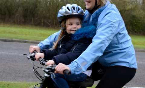girl on a front child seat with her mum