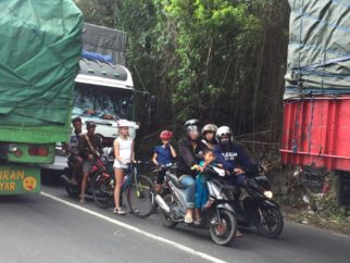 Cycling with kids in the traffic on Indonesia Bali