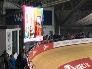 Ethan and Lucy's photo on the screen at the velodrome