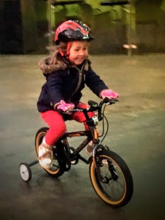 GIrls on bicycles - learning to ride a bike using stabilisers