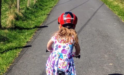 Girl on a bike - learning to ride in a dress