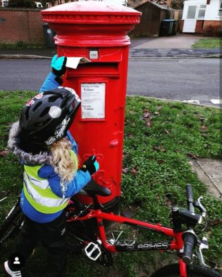 Girls on bicycles - posting a letter to Santa by bike