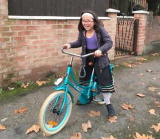 Girl on bike wearing normal clothing