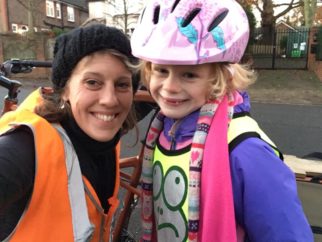 Girl cycling on her bike during the cold winter months 