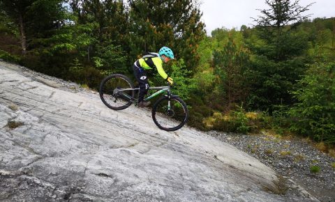 Girl riding downhill at Fort William mountain bike trails
