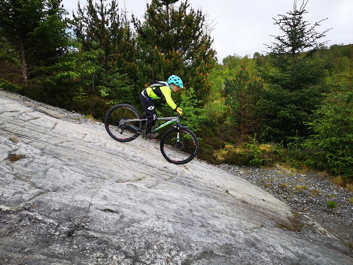 Girl riding downhill at Fort William mountain bike trails