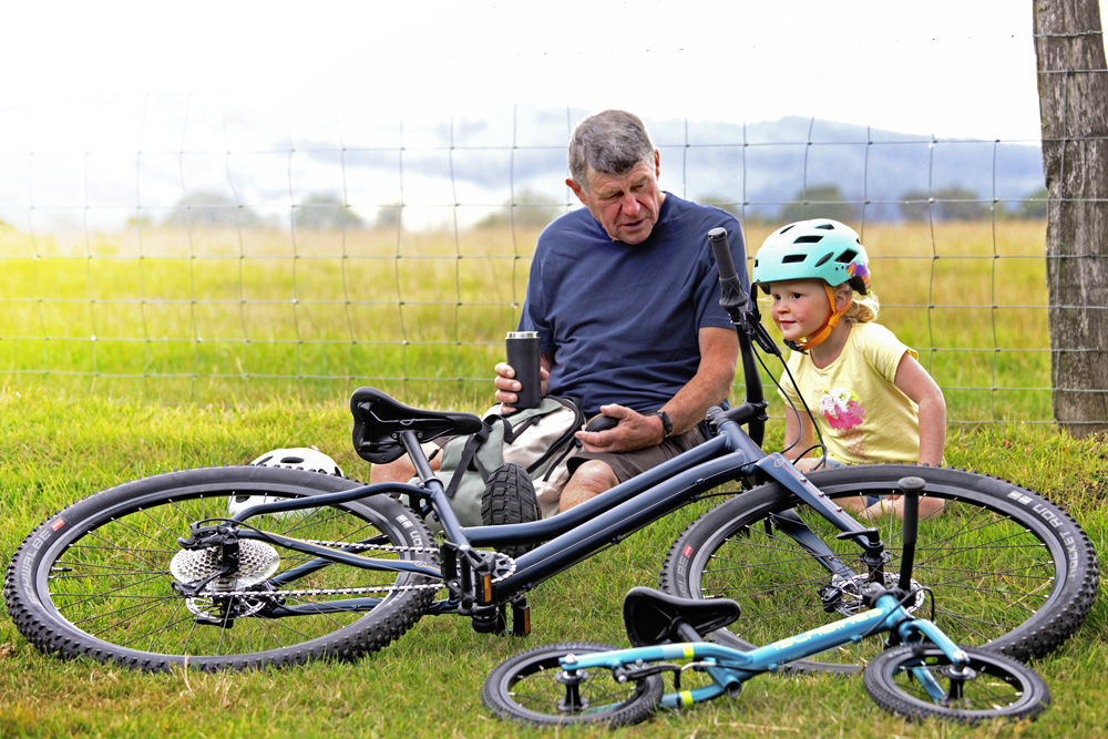 Islabikes new 2020 range bikes and riders sitting on grass