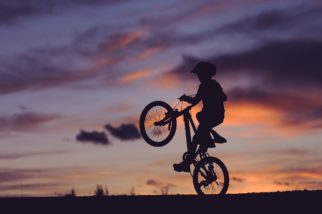 Child doing wheelie on bike