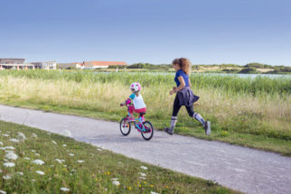 Jogging with your child as they cycle