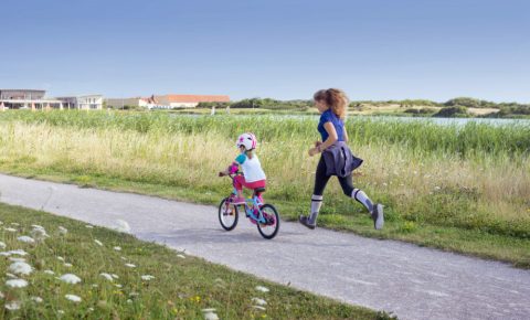 Jogging with your child as they cycle