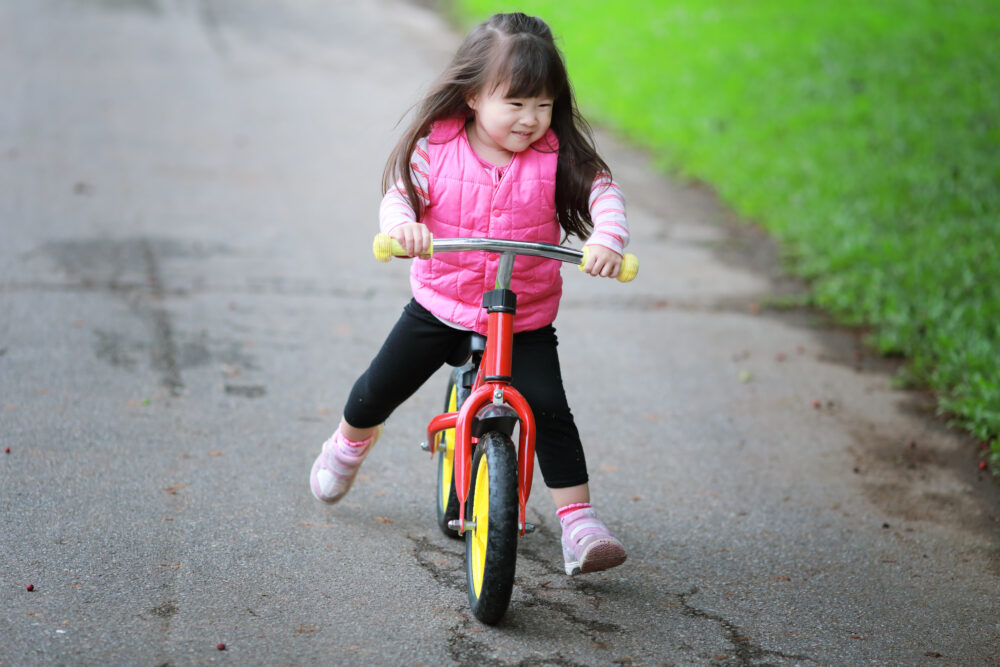 A balance bike in use showing why it's better than using stabilisers
