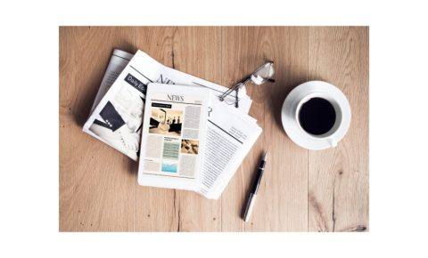 Family Cycling News - newspaper and coffee cup on table