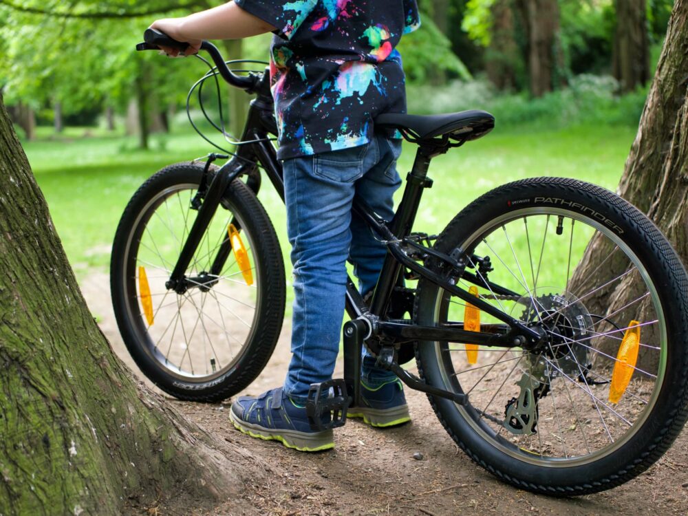 Best kids' bikes: a child riding a specialized jett bike through some trees