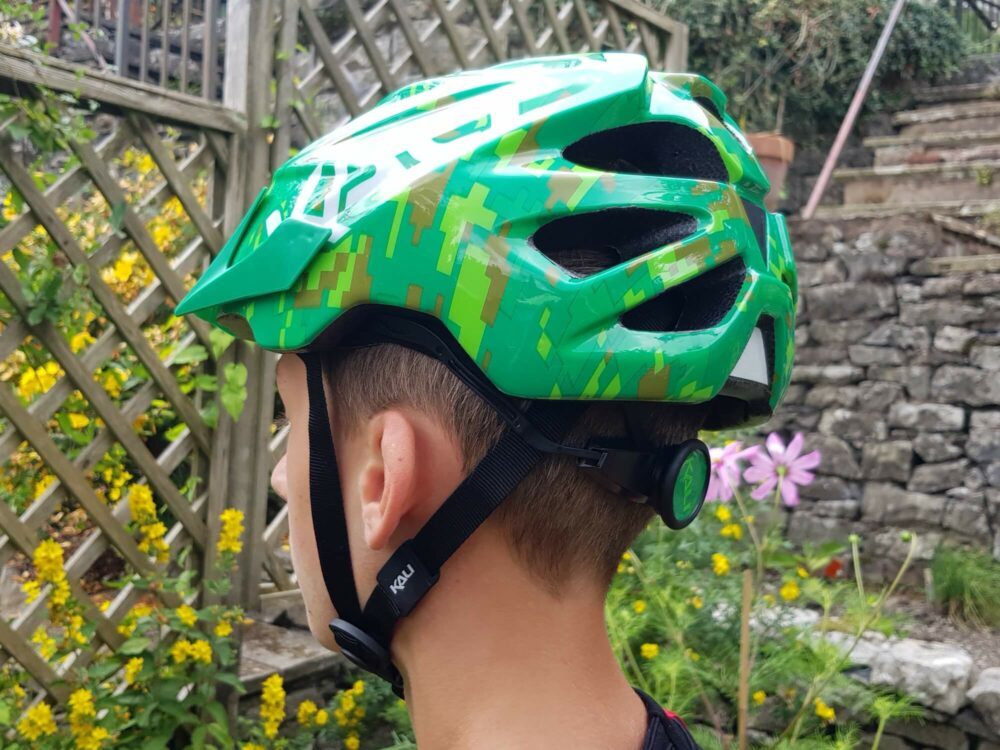 Photo showing our 13 year old reviewer wearing the Kali Chakra kids cycling helmet and the positioning of the straps under his ears. 