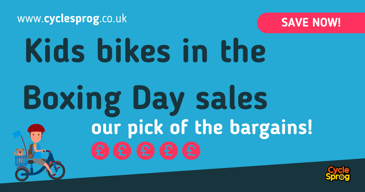 Boxing Day deals on kids bikes in words with two cartoon characters of children on bicycles and a big red box with Boxing Day Sales written on it