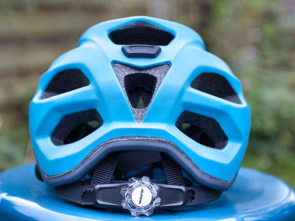 The Aplina Carapax Jr helmet from behind, showing the rear adjuster which is an iced white plastic which contrasts nicely with the blue of the helmet