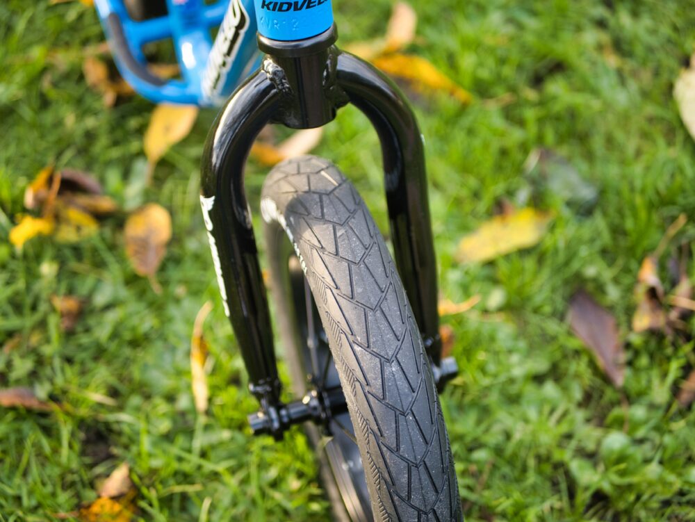 KidVelo Rookie 12 balance bike review - close up photo of the pneumatic tyres and fork