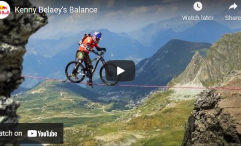 Kenny Belaey Balance film - photo of him riding a bike on a slack wire across an alpine valley